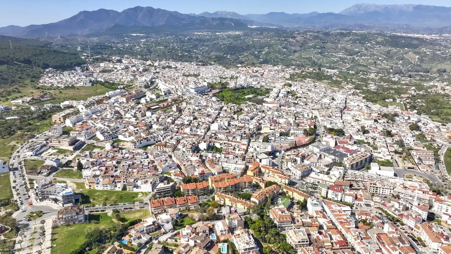 Aerial view of the whitewashed town of Alhaurín el Grande with the sierra behind
