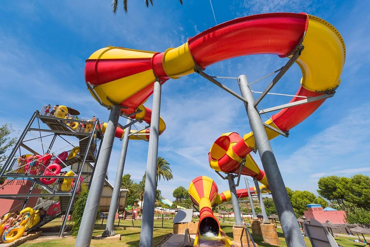 Tall corkscrew water slides against a blue sky at Aqualand Torremolinos