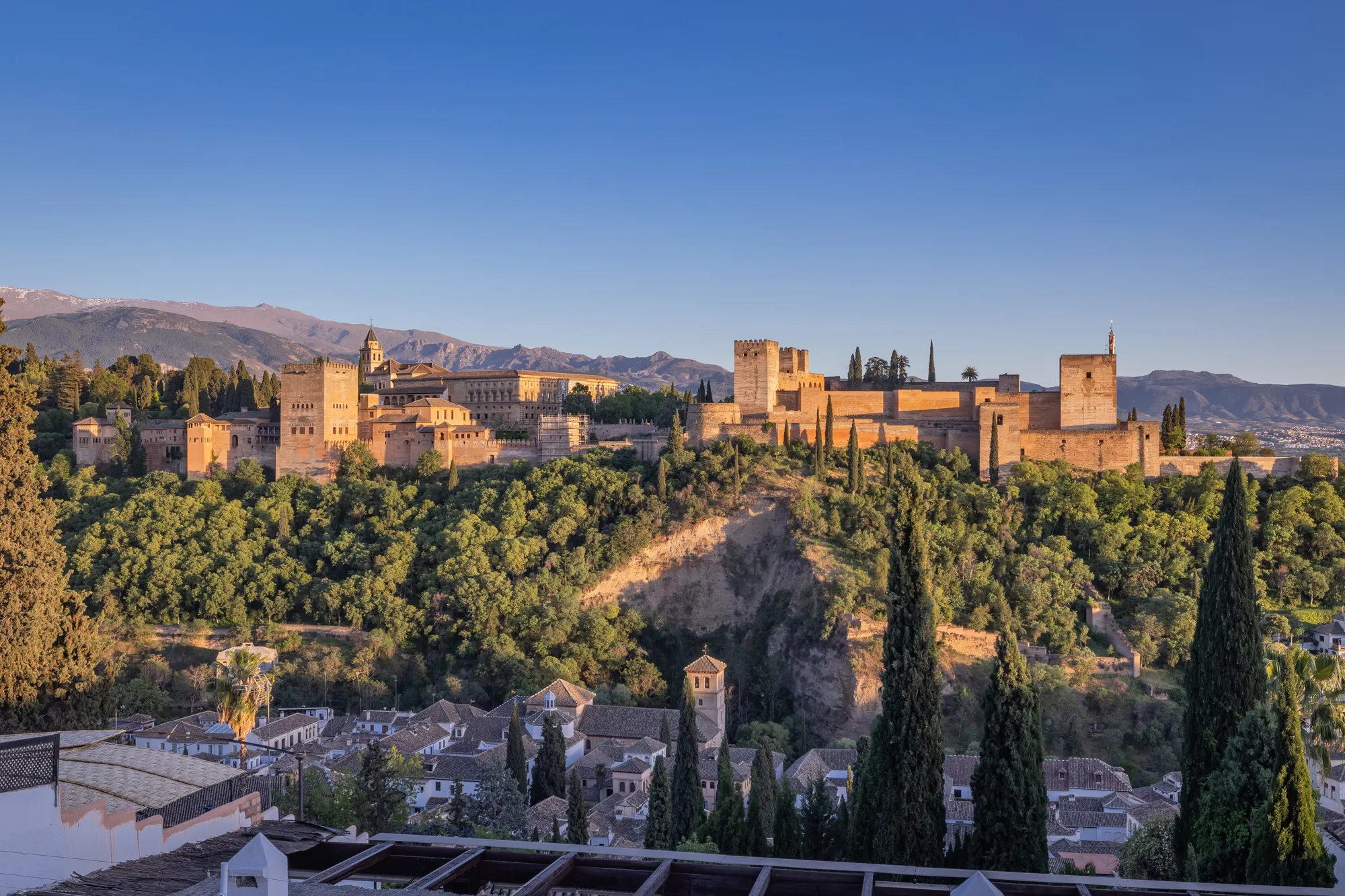 The Alhambra palace and fortress on its hill above Granada with the Sierra Nevada behind