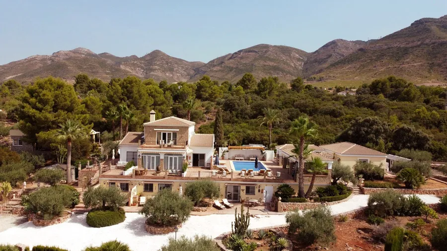 Aerial view of Finca Sonrisa, its villa and pool set in the hills