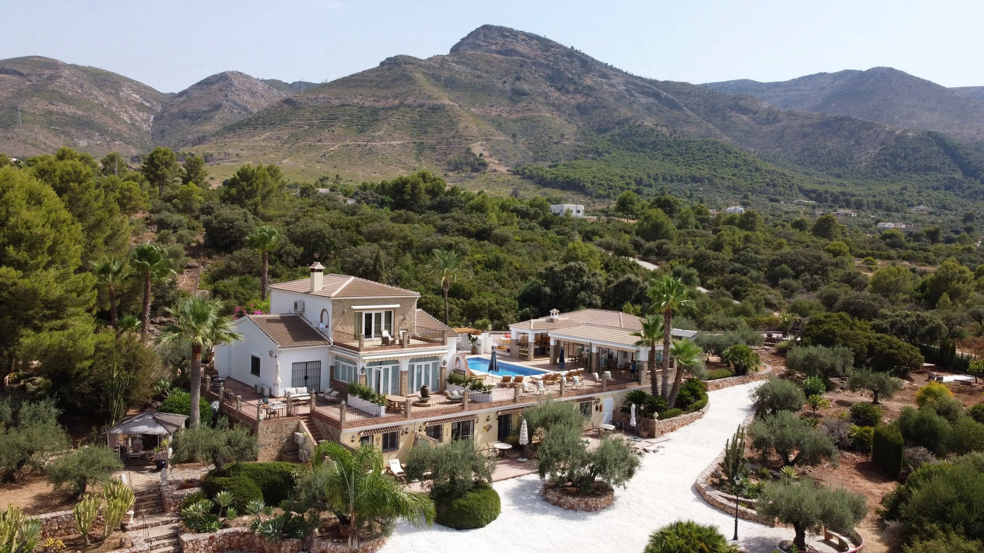 Aerial view of Finca Sonrisa: the villa, pool and gardens set in the hills of Alhaurín el Grande