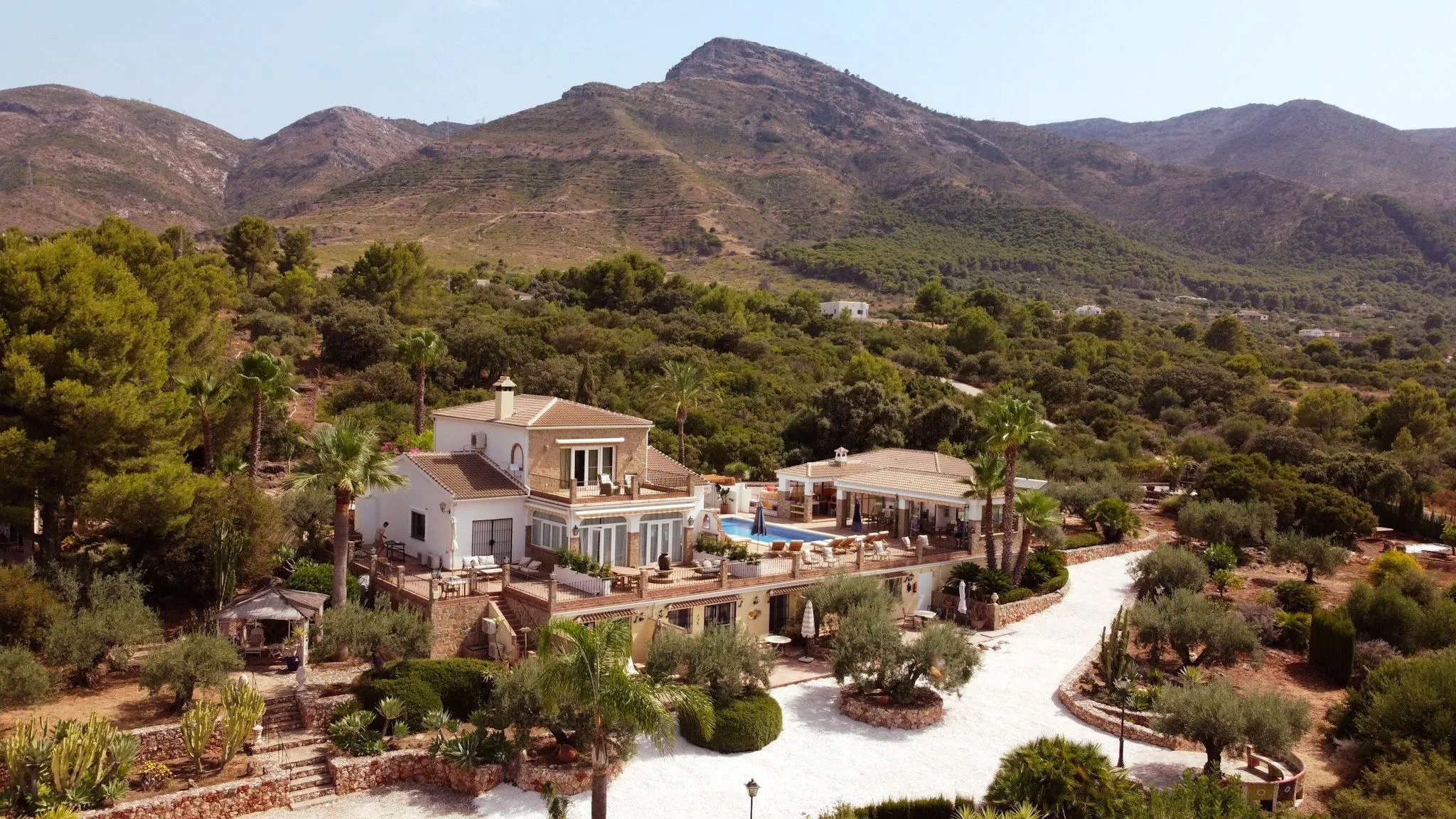 The villa with the sierra rising behind it