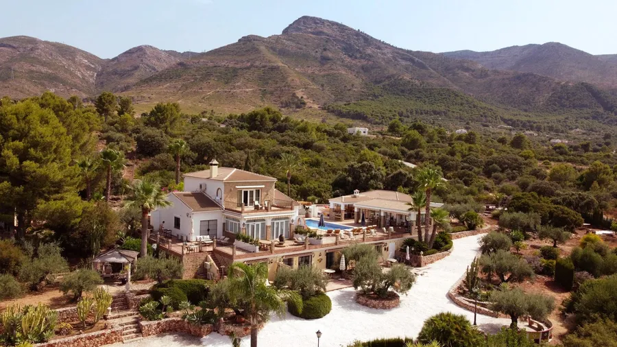 The villa with the sierra rising behind it